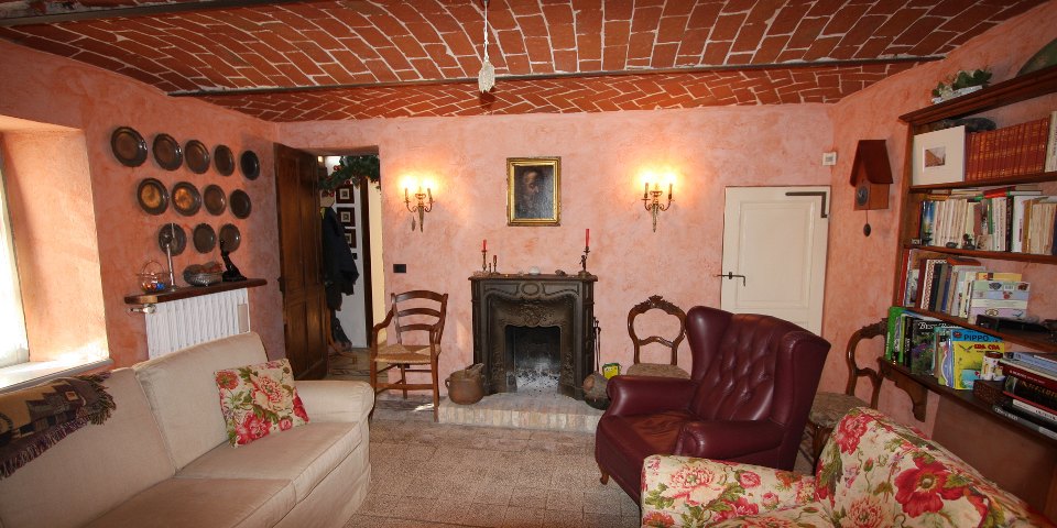
			The cozy living room has an antique fireplace
			