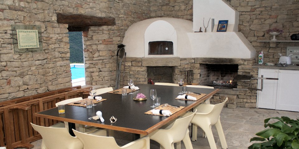 
			The summer kitchen in the portico next to the pool
			